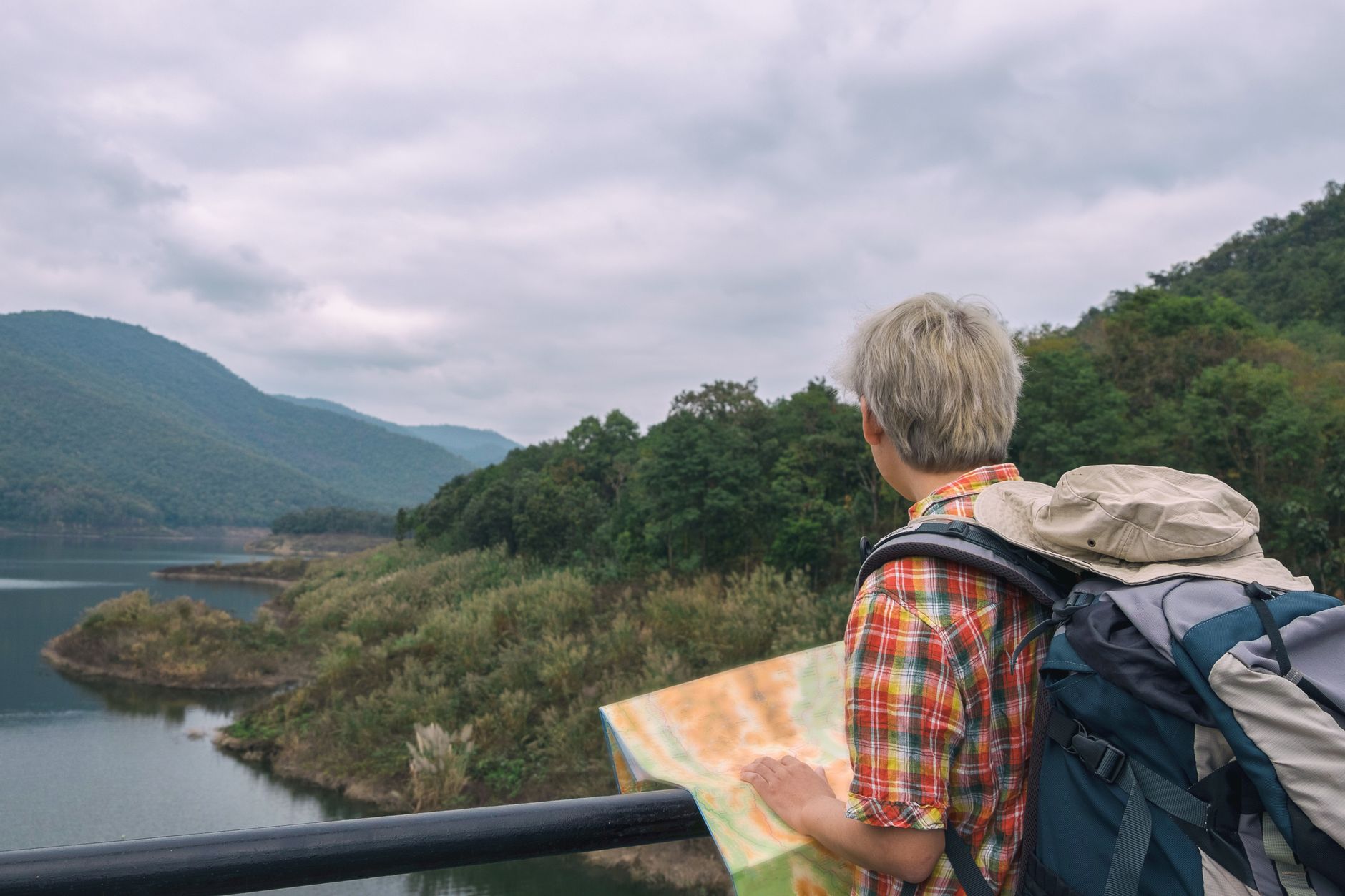 Hiker examining topographic map in Fiordland New Zealand